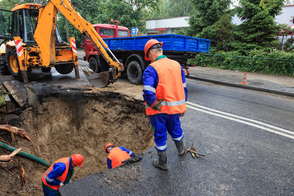Workers digging the road for a utility repair