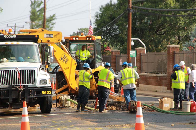Workers digging the road for a utility repair